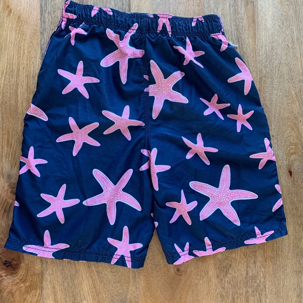 Navy blue swimming trunks with pink star fish